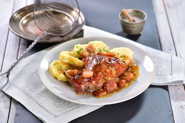 Honey and beer baked rabbit served with homemade potato dumplings