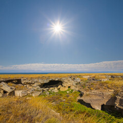 prairie with stones under a sparkle sun