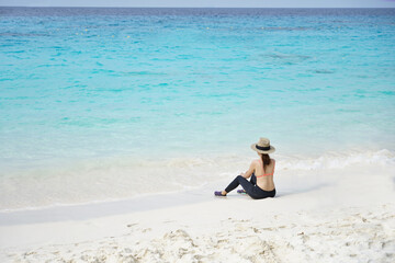 Fototapeta na wymiar Young bikini woman sitting on the beautiful beach at similan islands.