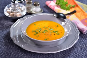 Pumpkin soup made with apples and ginger in a bowl