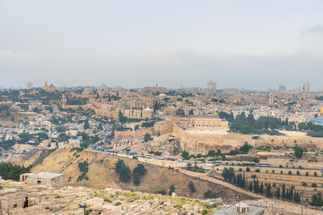 Fototapeta na wymiar The old city Jerusalem and monumental defensive walls. The Jewish Cemetery on the Mount of Olives, the Dome of the Rock. Most important world holy places. Israel landmarks