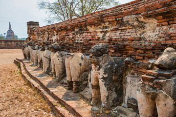 Elephant sculptures at ruins of brick chedi in Wat Maheyong temple. Historic architecture of Ayutthaya, Thailand 