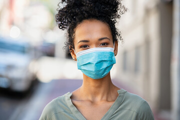 Happy african woman wearing face mask during pandemic