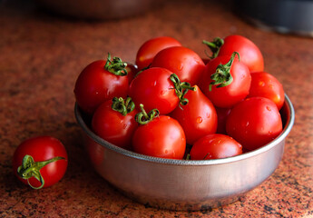 Fresh cherry tomatoes in a bowl on table