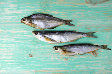 Dried salted fish on a blue background. Homemade food, beer snack. High quality photo