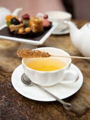 Cup of tea and cane sugar on the background of the cookies