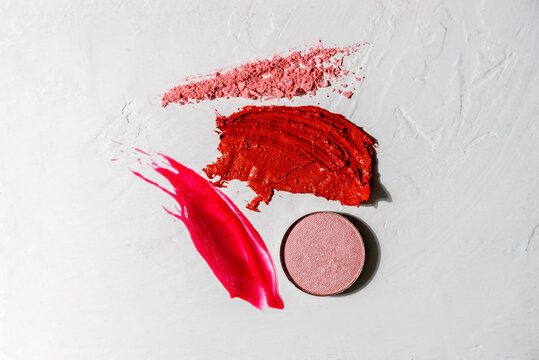Composition of decorative cosmetic smears or swatches - lipstick, lip gloss, face powder on white