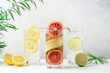Fototapeta premium Set of lemonades with red orange, lemon and lime. Summer cocktails on light background