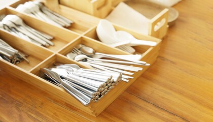 Plastic free july. Clean Stainless steel cutlery spoon, forks, knives well organized in a wooden...
