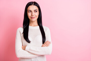 Photo portrait of woman with crossed hands wearing casual sweater looking empty space isolated on...