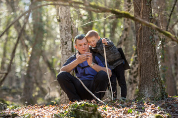 a boy and his dad found something in the forest, mushroom pickers or treasure hunters