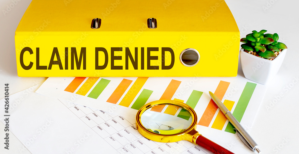 Poster office folder with text claim denied with charts, magnifier and pen