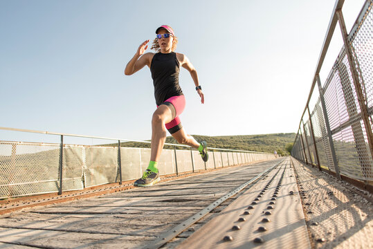 triathlete training on bridge jumping with big strides