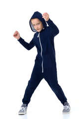 Preteen boy in blue warm overalls. Studio portrait.