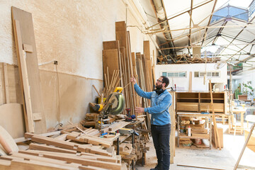 Fototapeta premium Craftsman as a carpenter in the joinery warehouse
