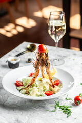 Caesar Salad with Shrimp. Caesar salad with king prawns in a white plate. Restaurant menu, dieting, cookbook recipe