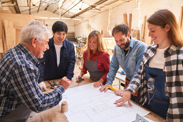 Masters and apprentices discuss construction drawings