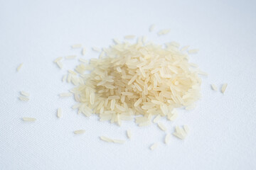 A bunch of Thai jasmine rice. Pile of white basmati rice on white background. Stack of rice