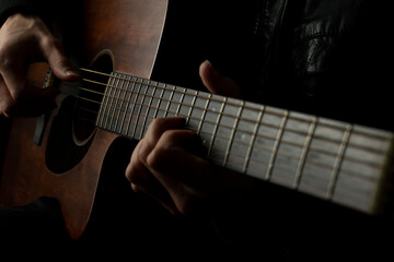 Fototapeta na wymiar person playing acoustic folk guitar