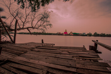 Evening nature background along the river,overlooking the Buddha image by the river (Wat Prasasopon,Wat Bang Krut), atmosphere is surrounded by mangroves and the wind blows through a cool blurred