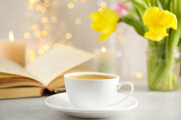 Cup of aromatic coffee on white table