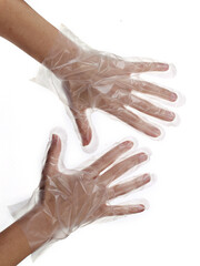 A woman's hands in a disposable transparent glove made of polyethylene isolated on a white background. Personal protective equipment.