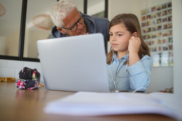 father with daughter home schooling