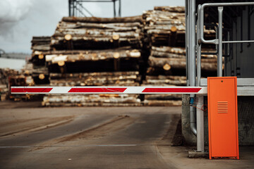 lowered barrier at the entrance to the factory. a pass is required for a restricted object. closed...