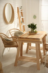 Stylish wooden dining table and chairs in room. Interior design