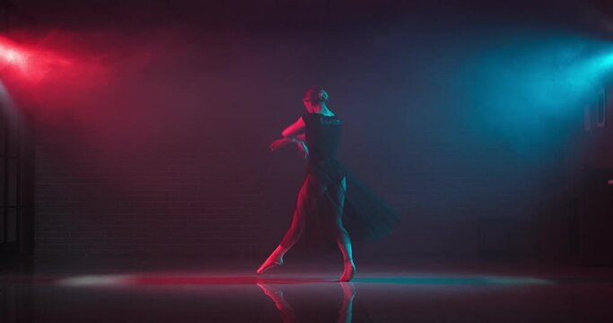 Beautiful young ballerina dancing on stage