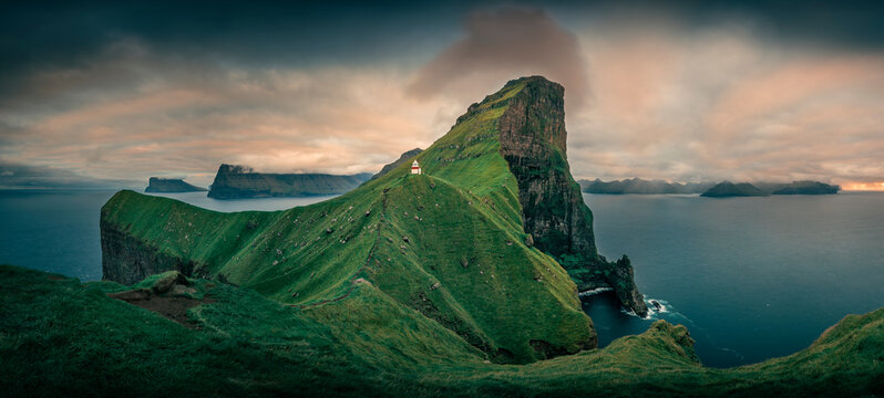Panorama at Lighthouse with steep cliffs during sunset on Faroese island Kalsoy, Faroe Islands.