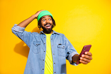 Photo of young happy smiling cheerful shocked amazed man winning on online victory isolated on...