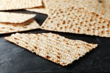 Traditional matzos on black table, closeup view