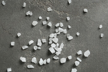 Fototapeta na wymiar Natural sea salt on grey table, flat lay