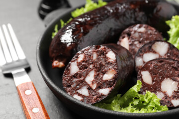 Tasty blood sausages served on grey table, closeup