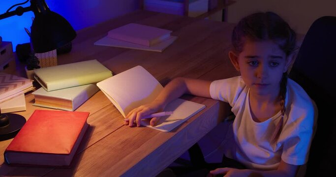 Little schoolgirl asking her mother for help while doing homework late in evening
