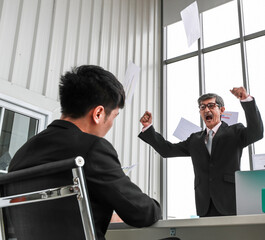 Portrait shot of aged Asian businessman supervisor blaming a young subordinate seriously. Old man...