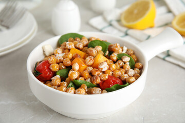 Delicious fresh chickpea salad on light grey marble table