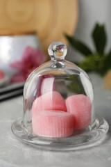Glass cloche with delicious mochi on grey table. Traditional Japanese dessert