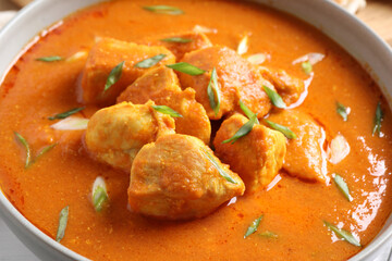 Bowl of delicious chicken curry, closeup view