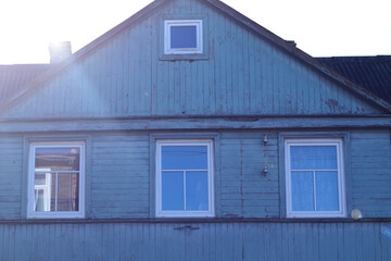 old blue wooden house with white windows