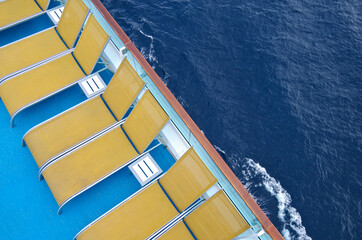 Luxury sun loungers and deck lounge chairs on outside terrace, patio or balcony sun pool deck of...