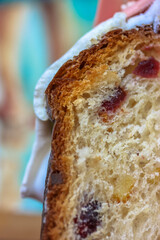 Easter cake with white icing, meringue, pink decorative chocolate balls, nuts.
