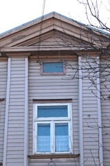 old brown wooden house with small window
