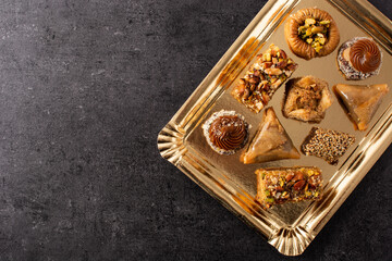 Assortment of Ramadan dessert baklava on black background. Top view. Copy space