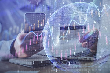 Double exposure of man hands holding a credit card and Forex graph drawing. Stock trading and digital fintech in Internet E-commerce concept.