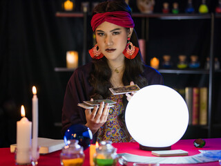 Asian fortune teller shuffling cards