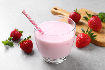 Delicious strawberry drink on light grey table