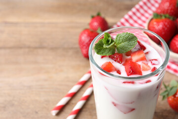 Delicious drink with strawberries on table, closeup. Space for text