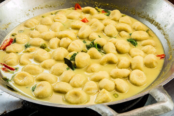 Cooking fish ball green curry in pan, Thai famous food.